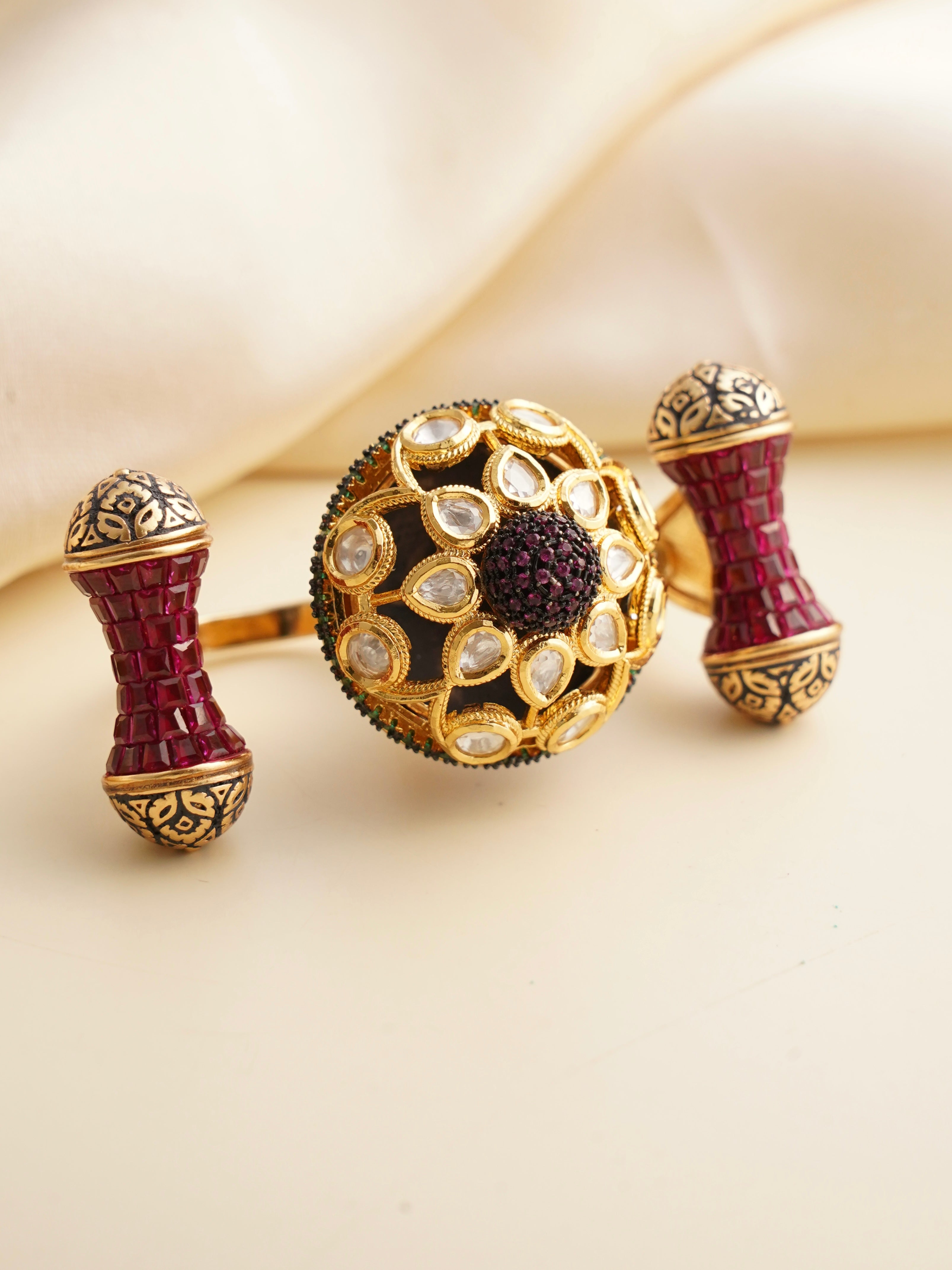 Ruby dual finger ring with gold detailing and bold symmetrical open design